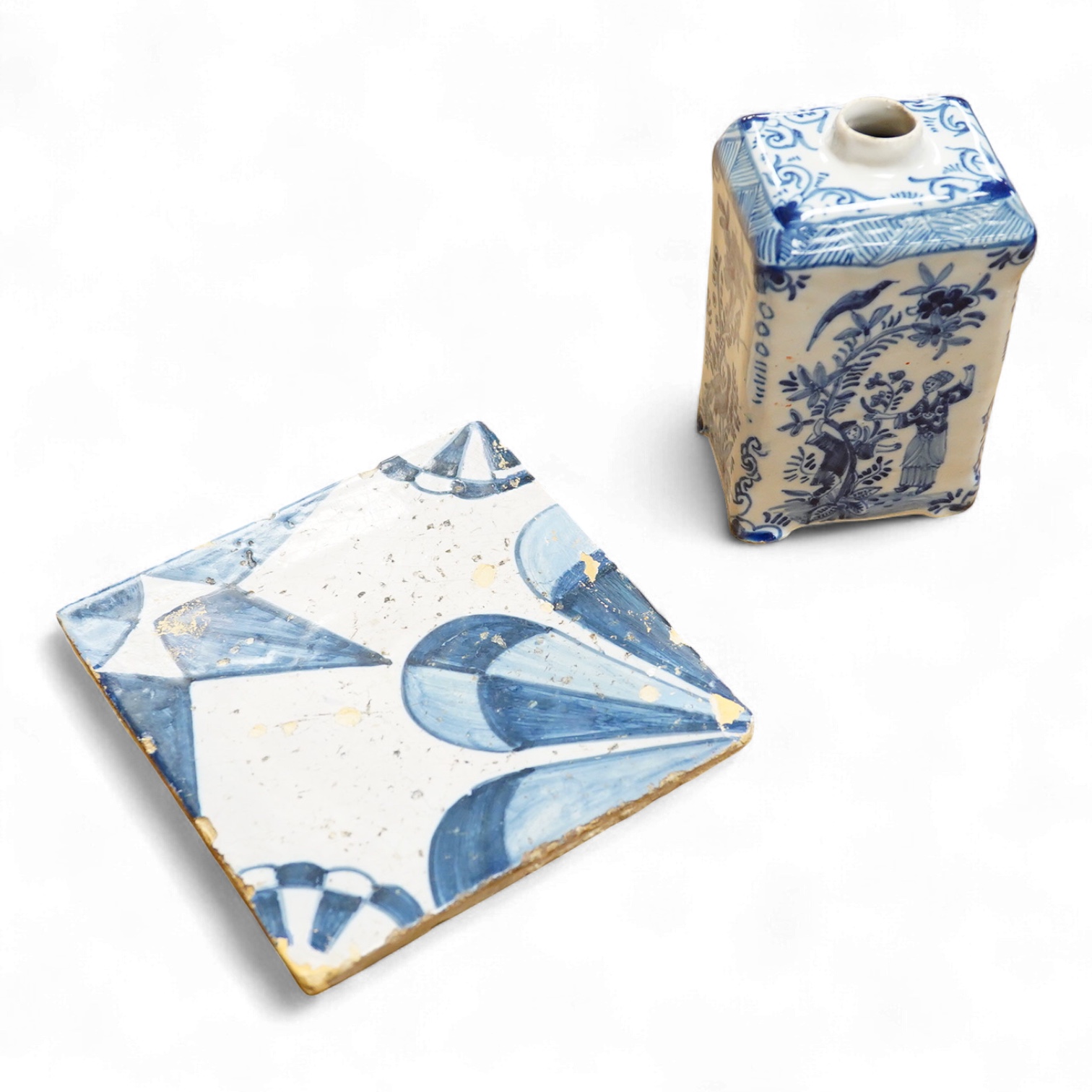 An 18th century Delft tea caddy decorated with figures and flowers and tile, 13cm square